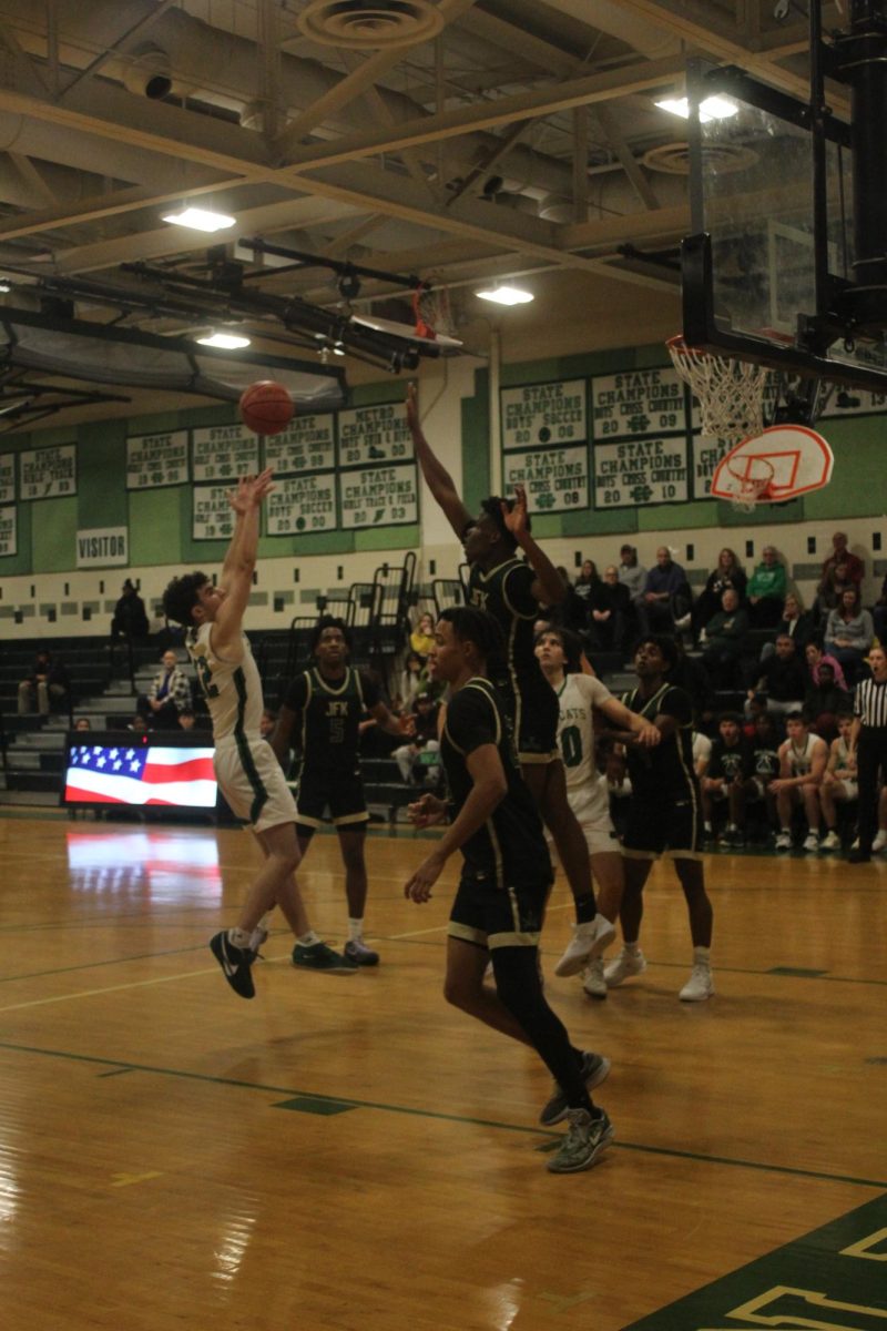 Senior Jordan Silverstein shoots a jumper against a Kennedy defender. Even with Silverstein's 13 points, the Cats struggled offensively, going cold from around the arc against the Cavaliers. The game ended with a final score of 63-49, keeping the Wildcats winless.