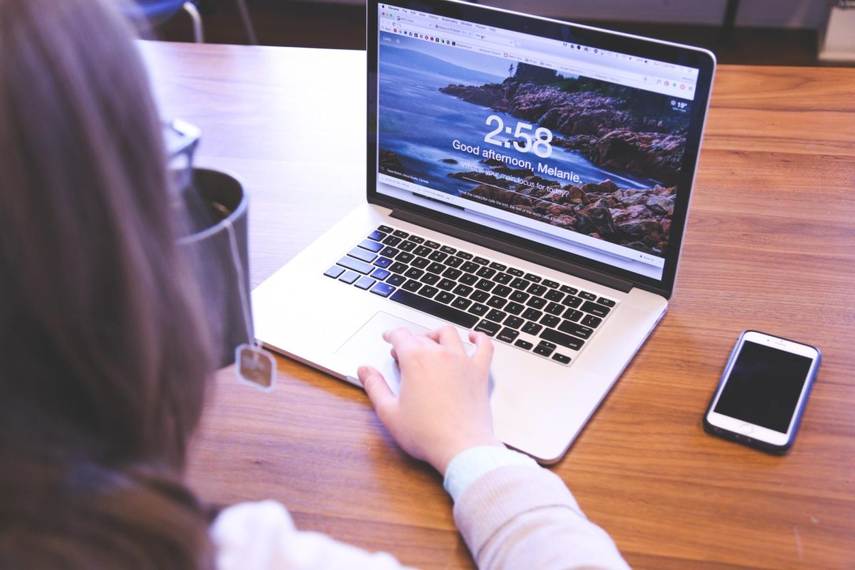 Student tries to focus on work, but keeps getting distracted by notifications on her phone. She has noticed a decrease in productivity since she started working next to her phone. (Courtesy PxHere)