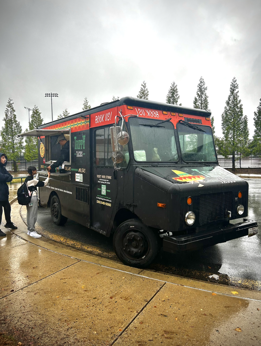 Trippy Taco food truck serves students in the WJ athletics circle. As the food trucks return, many students line up to get a taste of these specialties.