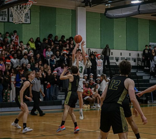 Sophomore Connor Luecking makes a pull-up jumper against B-CC. Luecking is one of many newcomers to the team that only features three seniors, which has made it hard for the team to find its footing.