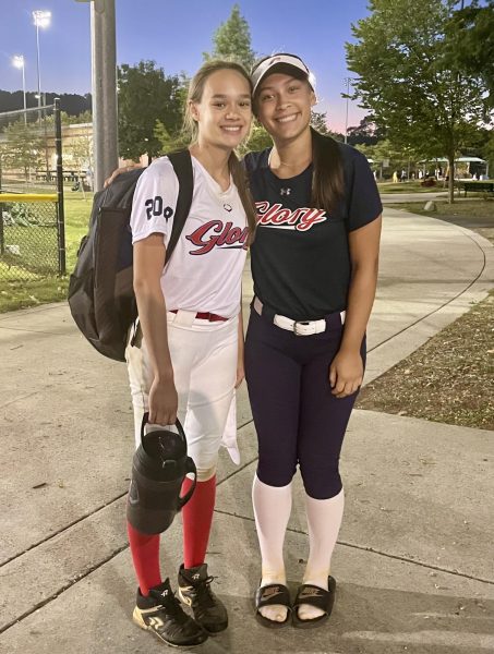 Sisters Quinn Reynolds (left) and Ella Reynolds (right) take a photo together after a club softball game. They are excited to take their sibling friendship to another level by competing for WJ together this spring. (Courtesy Quinn Reynolds)