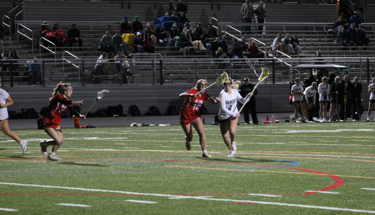 Senior captain Ginger Fishberg dodges by Blair's defender for a shot on goal. Fishberg scored two of the Cat's opening goals for the season and led them to their first win. 