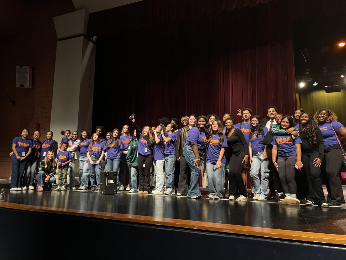 All the Minority Scholars Program facilitators gather on stage for a group photo. Students ranging from elementary school to high school arrived through buses and participated in the program.