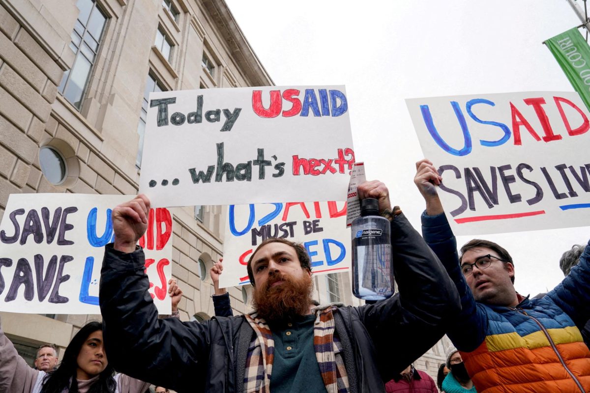 People hold placards outside the USAID building, after billionaire Elon Musk, who is heading U.S. President Donald Trump's drive to shrink the federal government, said work is underway to shut down the U.S. foreign aid agency USAID, in Washington, U.S., Feb. 3. (REUTERS/via SNO Sites/Kent Nishimura)