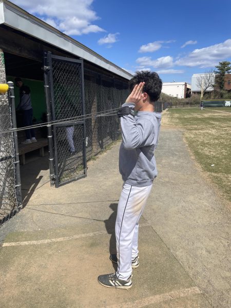 Senior Captain Brady Chan warms up with bands before practice. Chan broke the single-season runs record during the 2024 season.