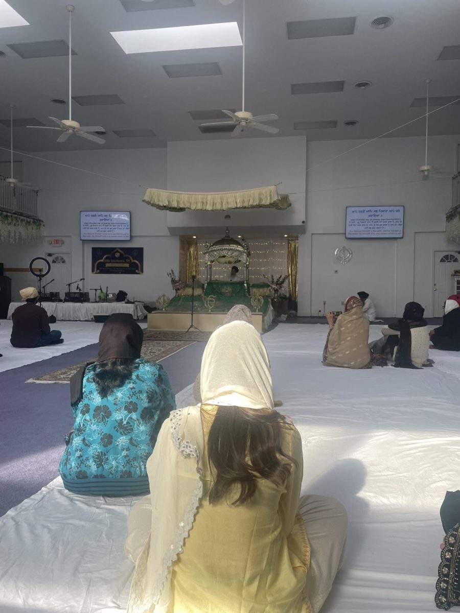 The prayer room of the Sikh Gurdwara, D.C. Attenders face towards the Guru Grant Sahib, a religious book which resides in the center of the prayer room. Gurudwara means home of the guru attendees cover their head when in the gurudwara. Food is served for free and always.