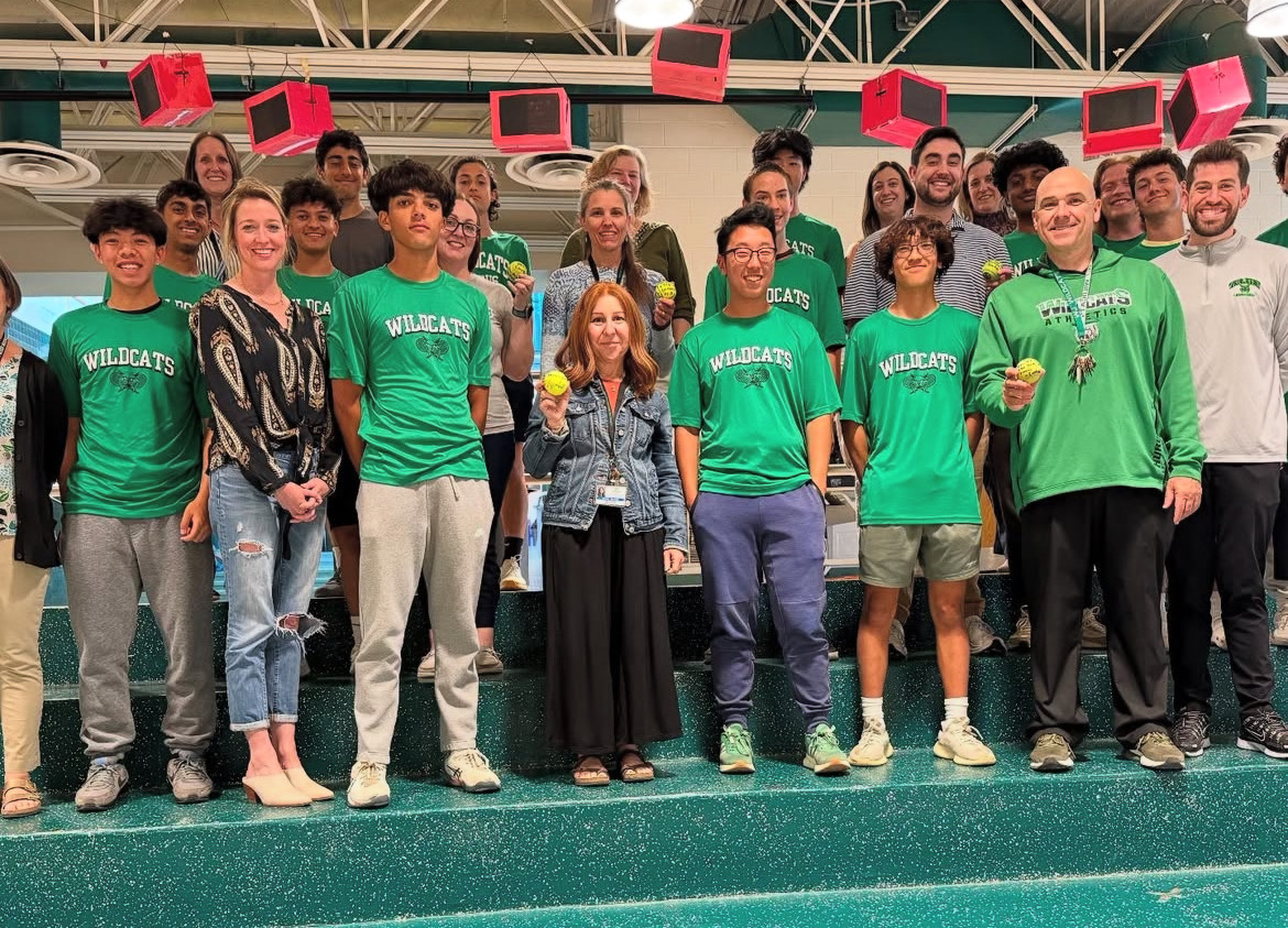 Varsity boys tennis and staff line up by the main office for a photo with their tennis balls. Each athlete wrote a note and gifted a tennis ball to their chosen staff to show appreciation.