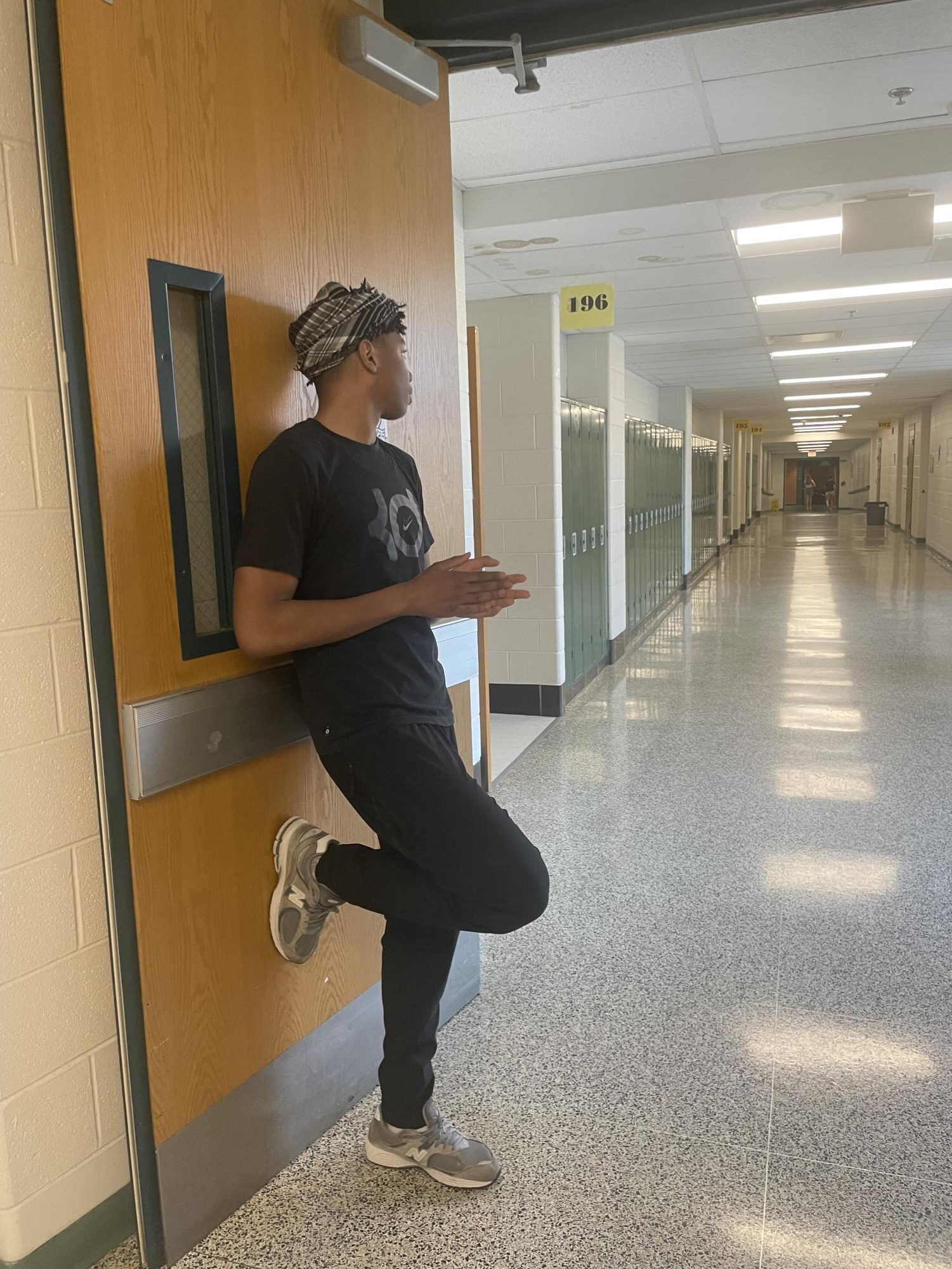 Senior Elijah Battle, nonchalantly, waiting for his fellow seniors to roam the halls together. Aura farming as he just stands there, but he is the opposite of nonchalant once his friends come around.