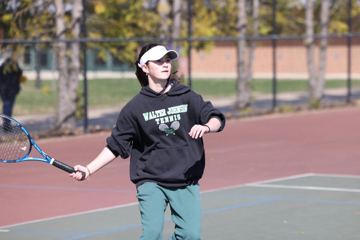 Junior Sonia Gass prepares to a recieve a serve during a practice. (Courtesy Charles Peters via Lifetouch)