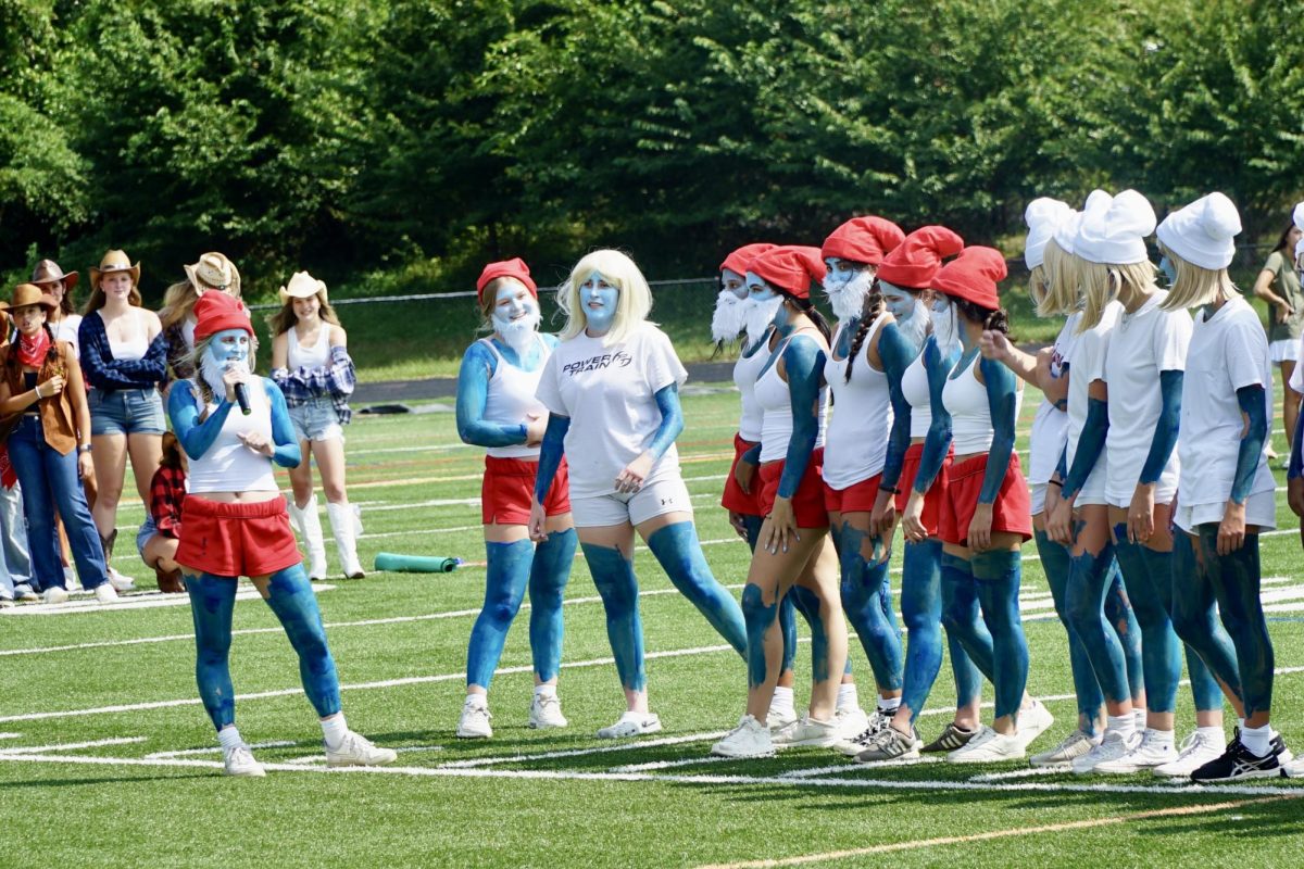 Senior Varsity Girls Soccer Captain Evie Avillo presents the senior players at the Spring pep rally. The girls decided to go with the Smurfs theme, with each grade dressing as a different Smurfs character. 