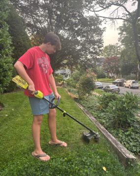 Senior Brooks Rathmell edges his lawn.  When Rathmell is older he wants to start his own landscaping company.