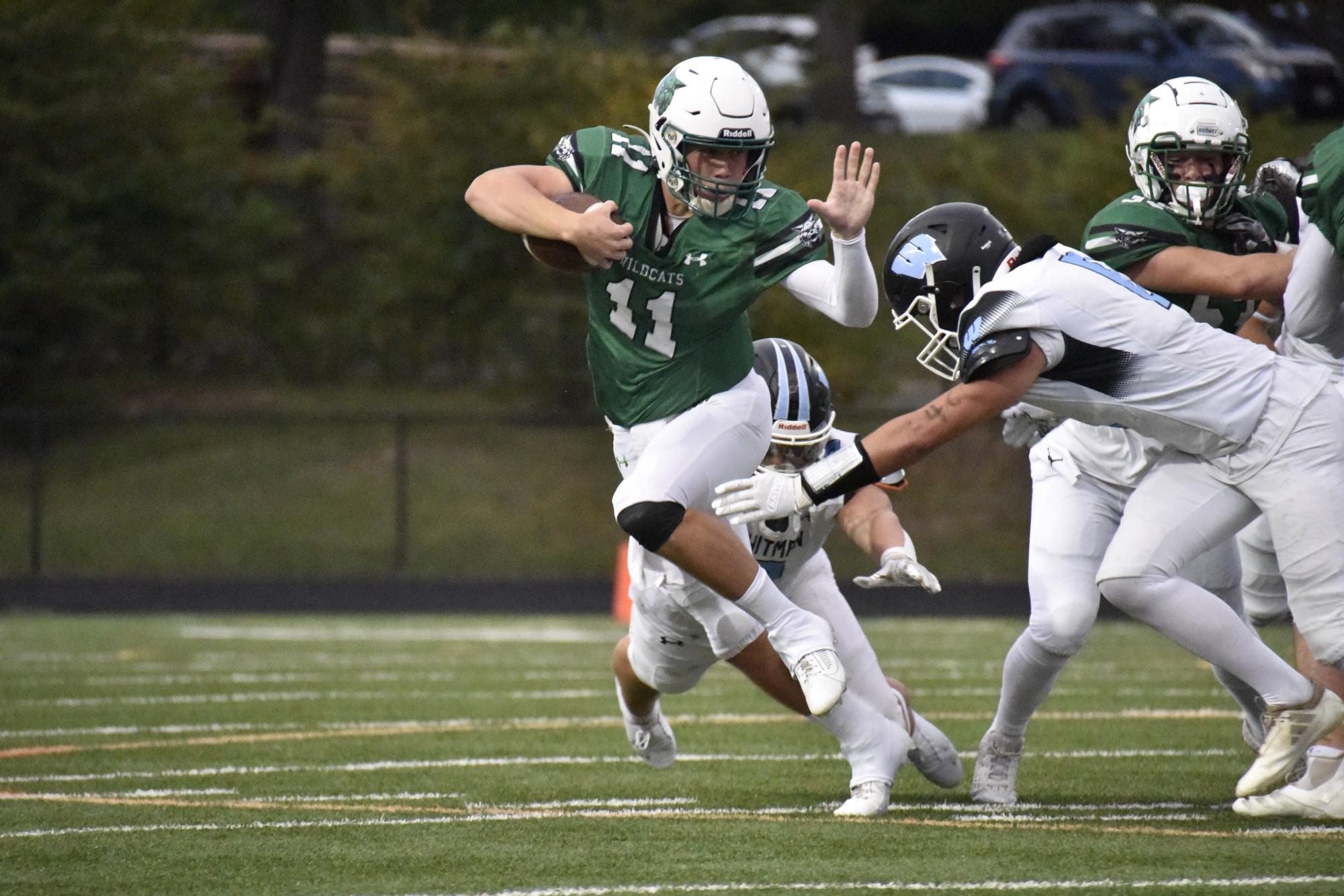 Senior quarterback Jake Forburger stiff arms his defender in an attempt to break a tackle during last year's game against Whitman. Now a senior in his 3rd full year in varsity, For burger looks to lead his team to the state championship bracket and beyond. (Courtesy Andrew Blake via Lifetouch)