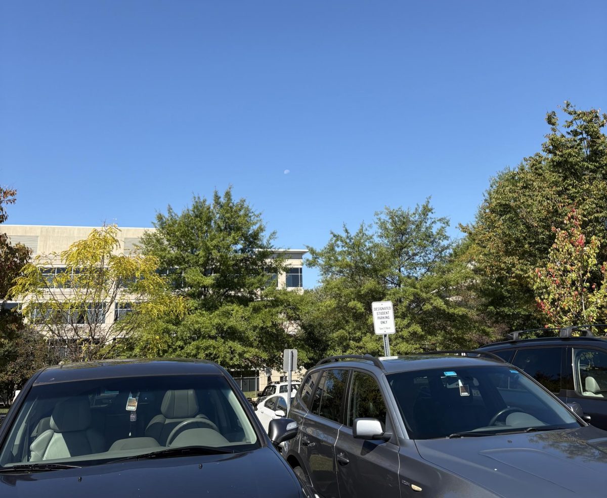 Two cars are parked in the student lot with parking passes. These were assigned in the first lottery the week before the first day of school.