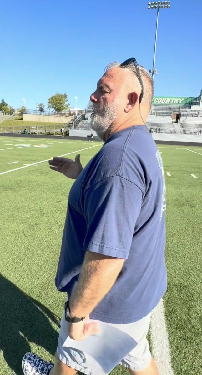 Flag football coach Butch Worden instructs his players during a practice to prepare for the team's second game of the season against Kennedy. "These girls have stuck with me and luckily we’re successful and they work hard and every single day they want to learn something new," Worden said. "It’s not like some other sports where people dread going to practice. All my girls love being at practice and we have fun and it’s a great culture."