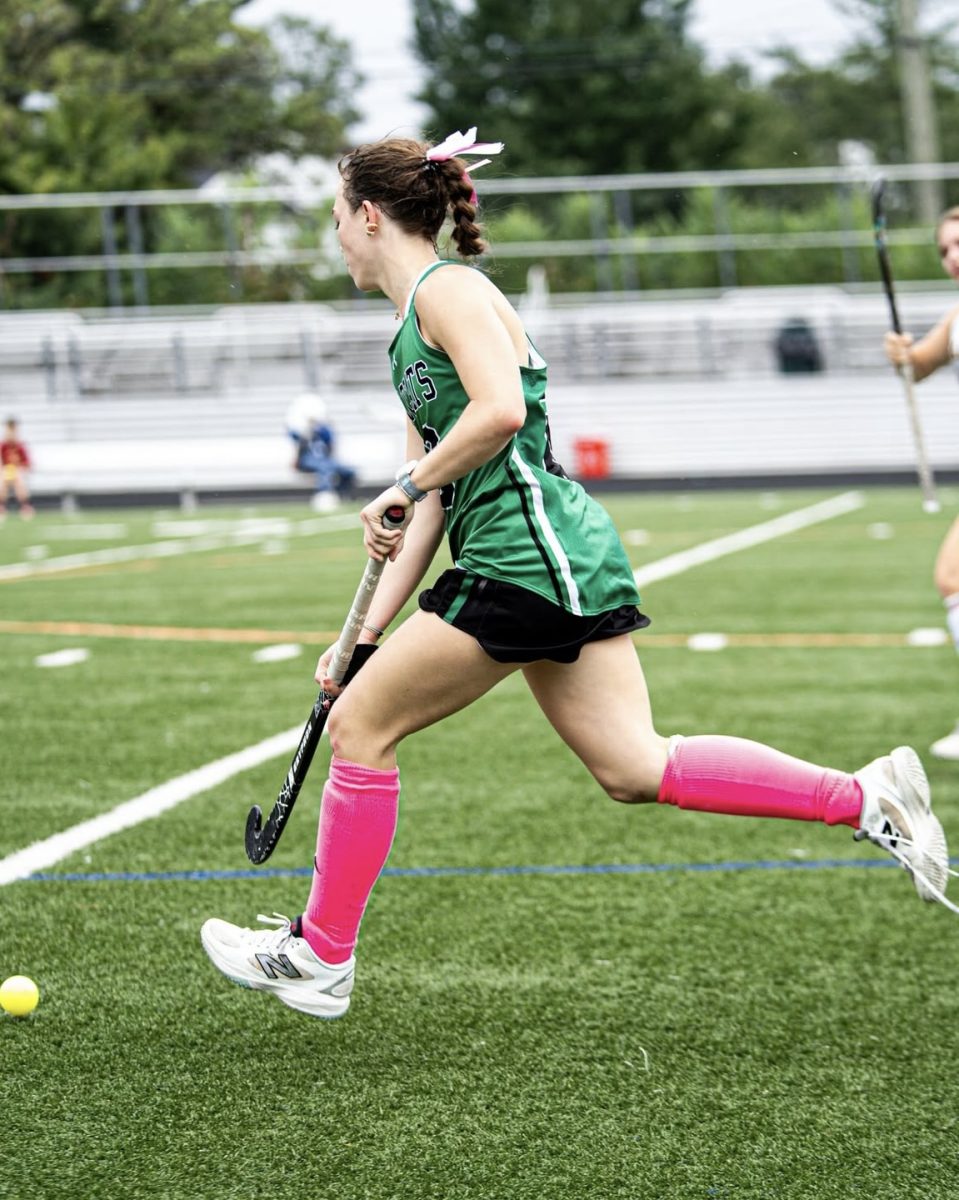 Sophomore Alina MacDermott handles the ball in a game against Wootton while moving down the field. The Cats will look to control possession of the ball as they look. (Courtesy Spencer Robinson) 