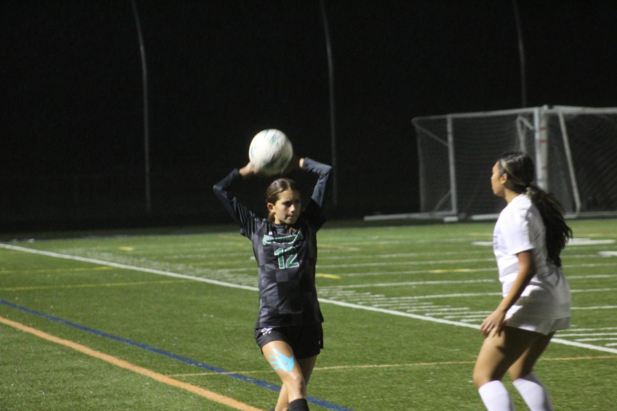 Defender freshman Elena Dugan delivers a decisive throw in to end an epic playoff match against Gaithersburg. The Cats went on to win in double overtime.