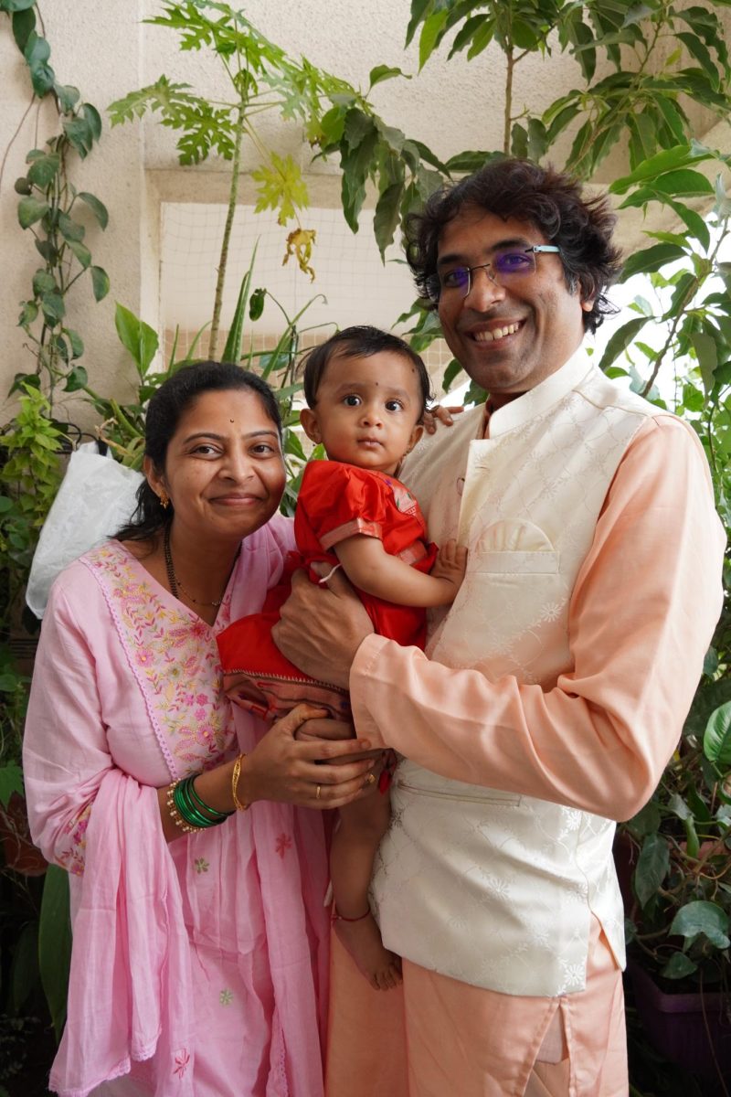 Mukta's parents, Gayatri and Vaibhav hold her in their arms after an afternoon pooja.