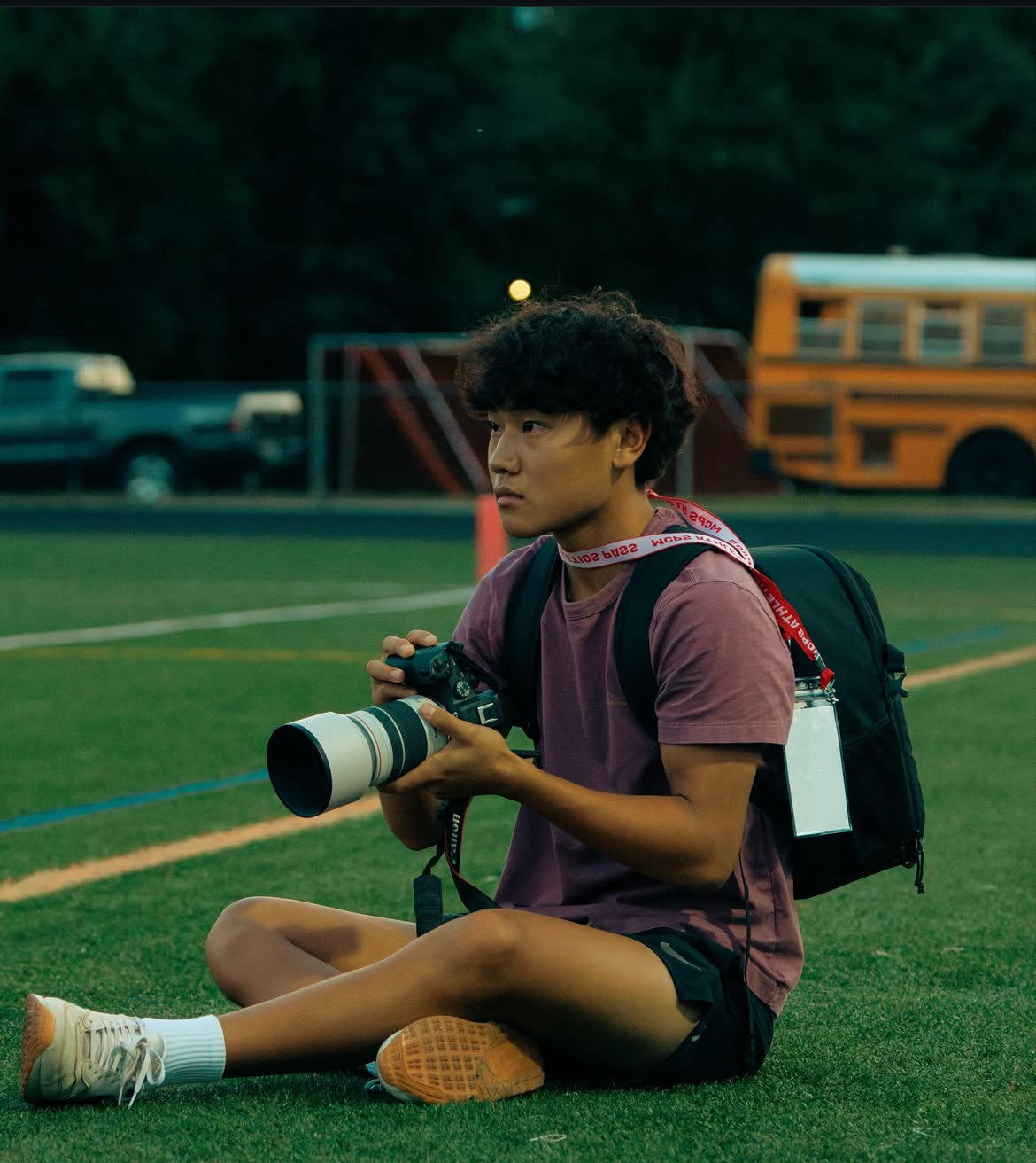 Junior Parker Kim sits down to take photos of WJ football athletes. Taking photos of his friends is a huge part of his love for photography. (Courtesy Elijah Goodman)