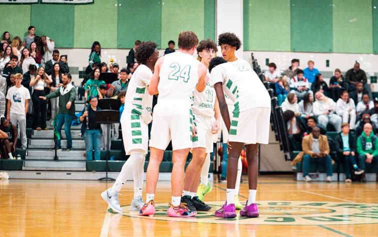 Senior guard Zaph Abbey composes the team before the 4th quarter starts. Teamwork like this readied the Cats to finish out the soon to be huge 57-42 opening-night win against Rockville.