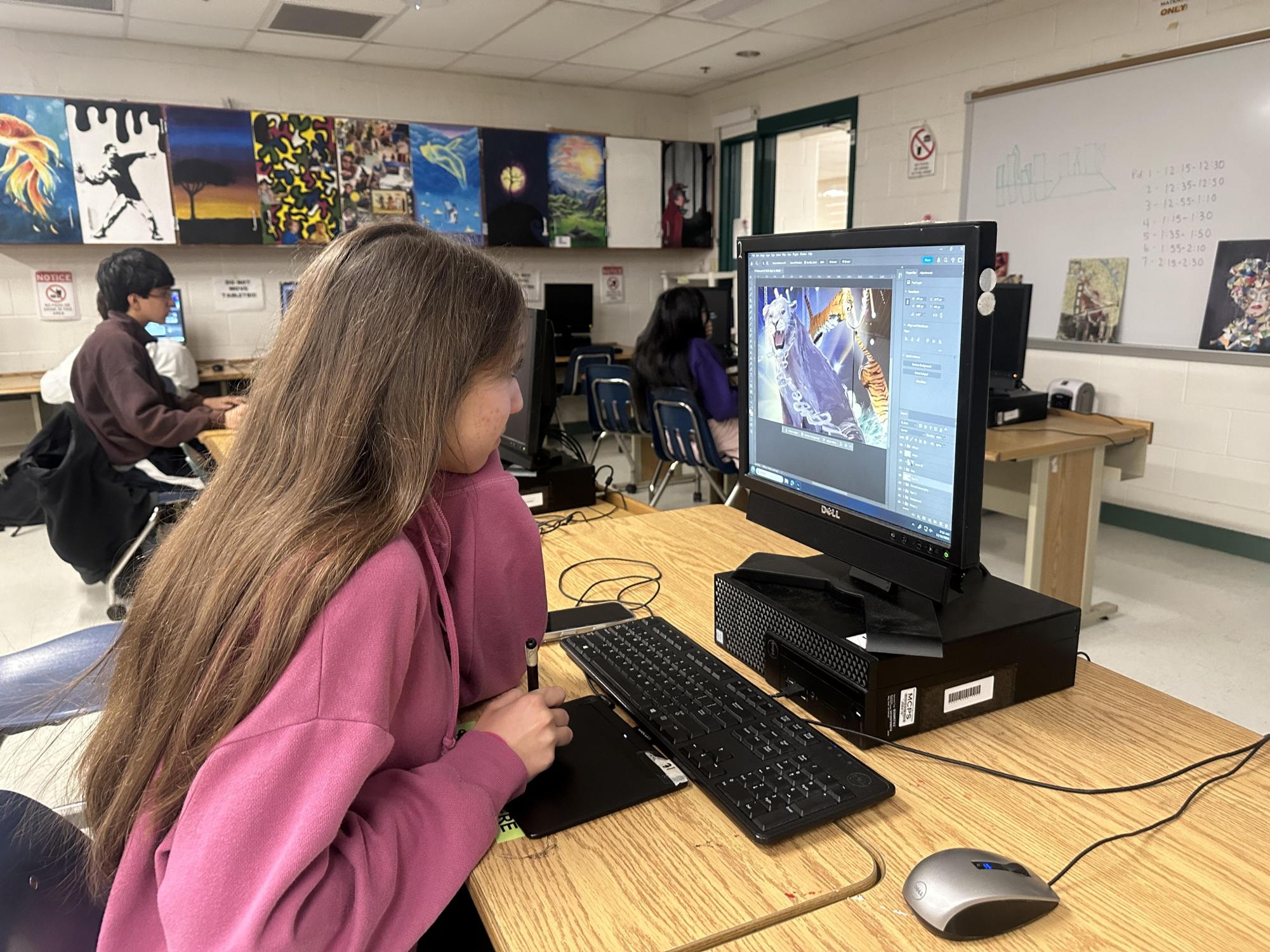 Junior Melin Ozturk works on her sixth piece. It's about the circus versus nature, and how their reality is the circus, when really, they are being controlled and their reality is being manipulated.