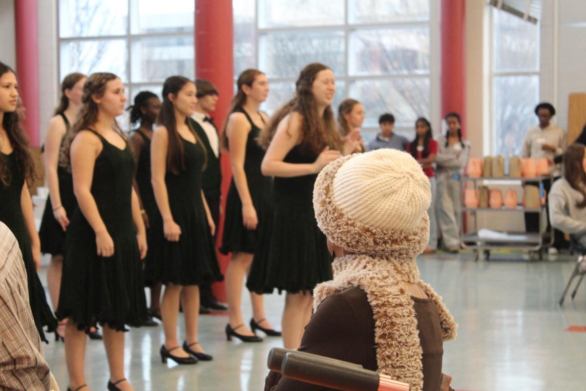 A senior citizen looks on as the WJ Choir performs.