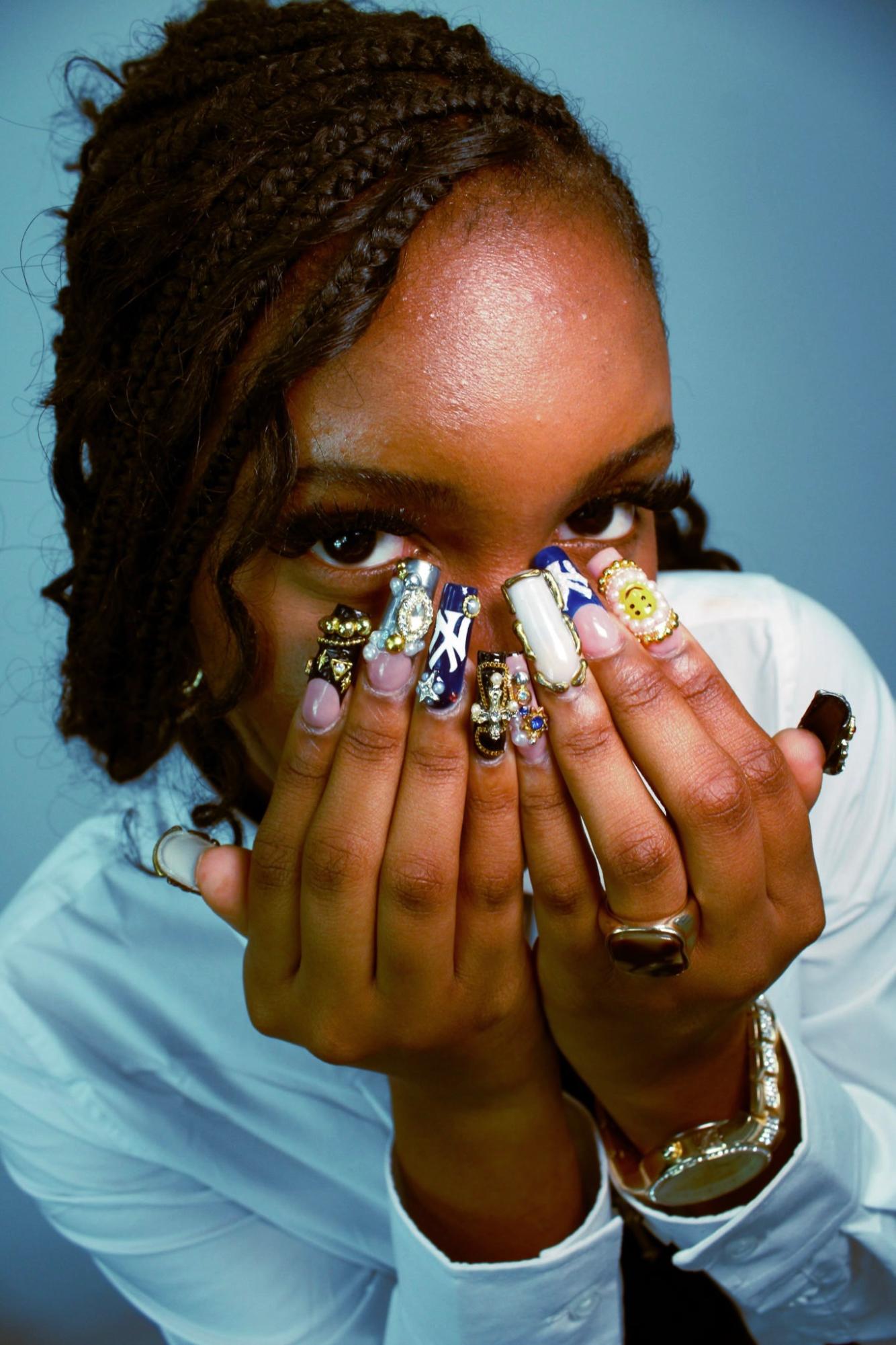 Alexis Hinds displays the intricacy of her work. Hinds has run Nailsxxlex for the past two years, and her business continues to grow.