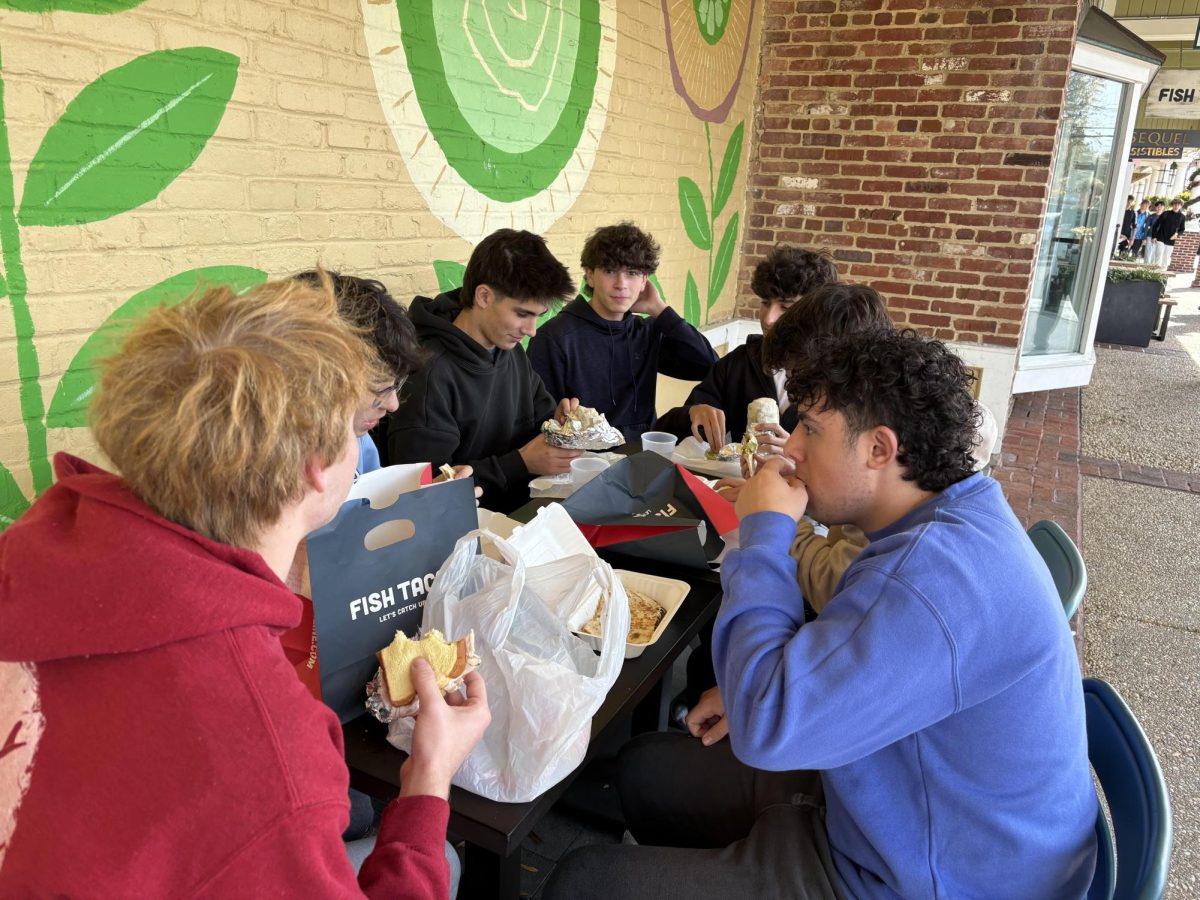 A group of students enjoy lunch outside of Fish Taco. The restaurant was extremely popular among students, many of whom would walk half a mile to eat there. Friday, Nov. 7 was the last day that the restaurant served WJ students during lunch.