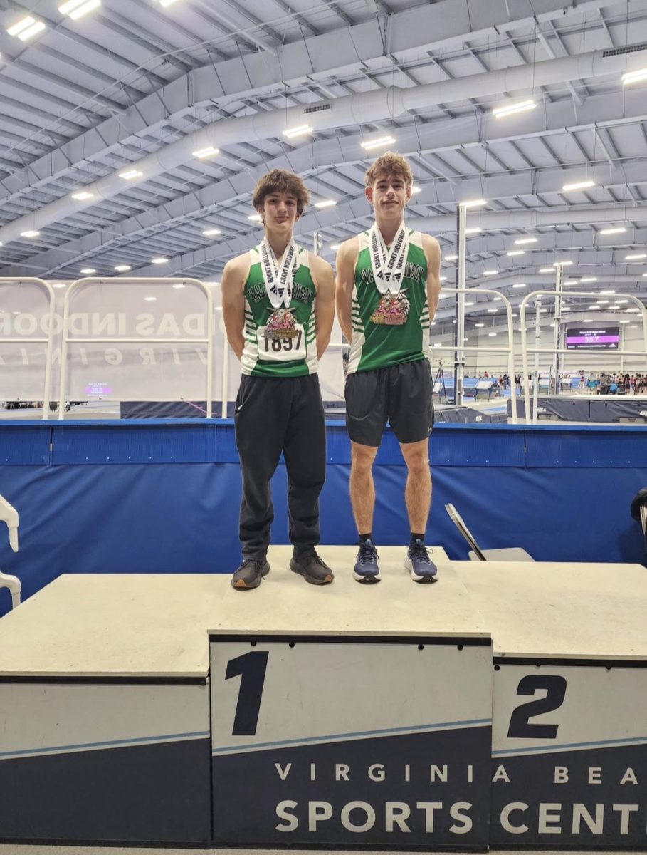Juniors Amadeo Apolinar and Jack Fiening take their places atop the podium at the Grant Holloway Holiday Invitational on Dec. 20 after finishing second and third in the 500m respectively. Apolinar tied the previous school record of 1:06.85, a record that would be broken by Fiening just a few days later. (Courtesy @wjtrackandfield on Instagram)