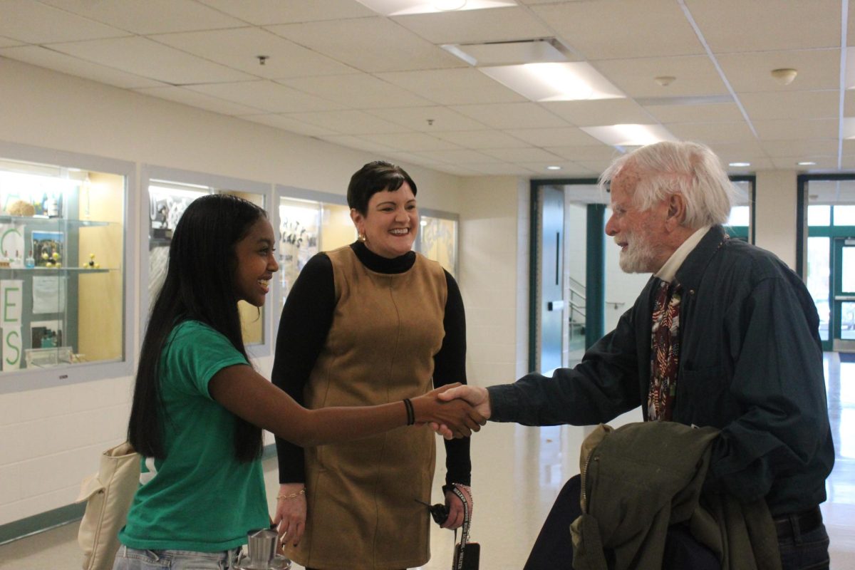 Current SGA President Mya Andriamalala meets and shakes hands with the first WJ SGA President Bill Hiatt Jr. Hiatt met all of the officers, who welcomed him while wearing their coordinated class of 2026 shirts. "It [was] just a wonderful experience and all. It's fascinating." Hiatt said.