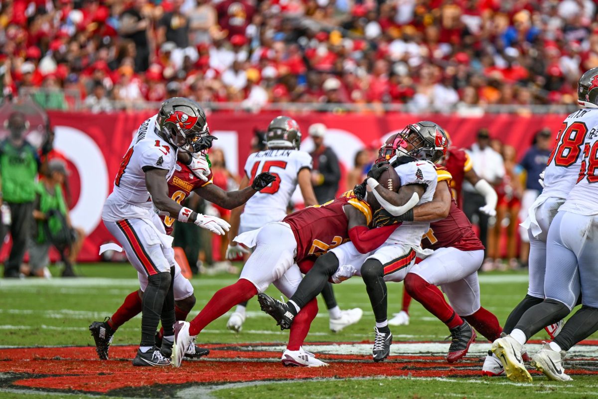 Multiple Washington Commanders defenders combine to make a tackle. Following a promising 2024-25 campaign, the Commanders fell short of expectations this season, finishing 4-13 on the year. (Courtesy Joe Glorioso/All-Pro Reels)