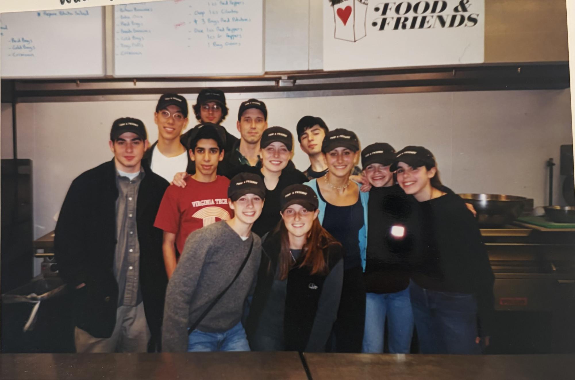 Amy Feygin '00 (far right) poses with a group of friends, as well as calculus teacher Michael Laukitis, during a volunteer outing to Food and Friends. "We learned a lot from the organization about AIDS and what individuals with HIV were struggling with," Feygin said. (Courtesy Amy Feygin)