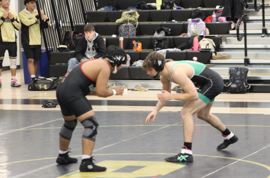 Jordan Alexiev starts off in a neutral stance as they circle each other during the match. Both athletes stay low and reach in, looking to set up their next move.