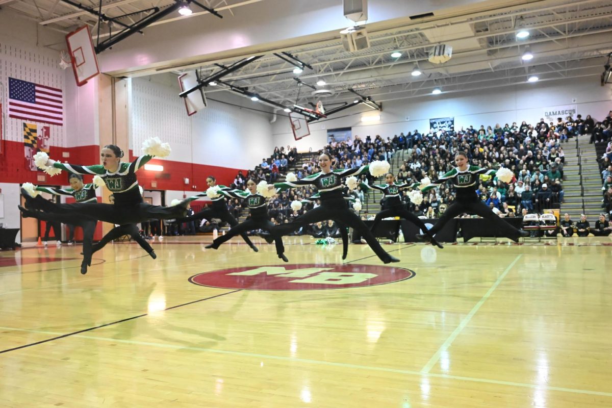 WJ Poms soars across the court in perfect unison, delivering a high-flying performance that stunned the judges. (Courtesy of Lottie Austegard)