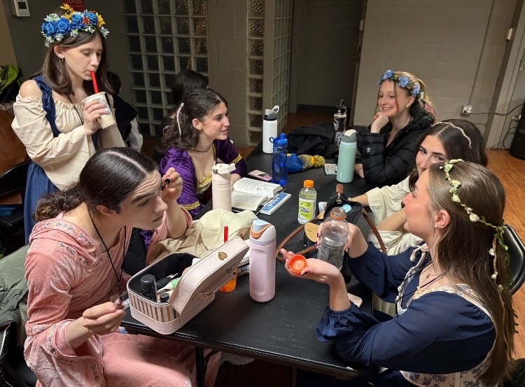 The madrigals relax in their performance outfits. 
"We were back stage for like 30 minutes, and then we got on stage and performed," senior Ellie Coffey said. (Courtesy Ellie Coffey)