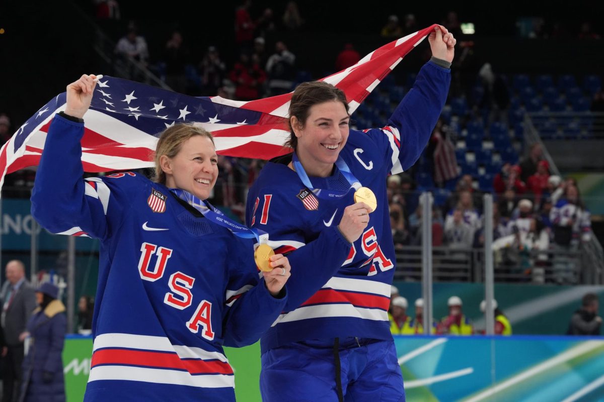 Feb 19, 2026; Milan, Italy; Kendall Coyne (26) of the United States and Hilary Knight (21) of the United States celebrate after winning the gold medal in women's ice hockey, defeating Canada during the Milano Cortina 2026 Olympic Winter Games at Milano Santagiulia Ice Hockey Arena. Mandatory Credit: Amber Searls-Imagn Images