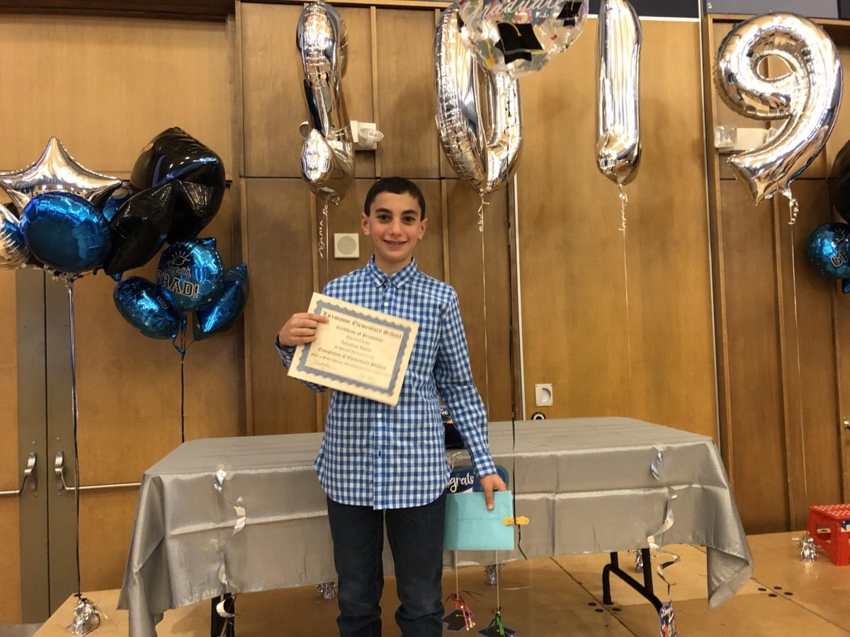 A young me proudly displays my elementary school promotion certificate in 2019 after finishing 5th grade at Luxmanor. (Courtesy Jonathan Bahat)