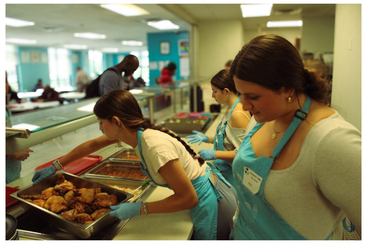 Food4All president Nicola Alexiou, outreach manager Hailey Lawson, and member Christina Alexiou provide a helping hand at a local food shelter, a common club activity, to help out the local community. (Courtesy Ryan Heminsley)