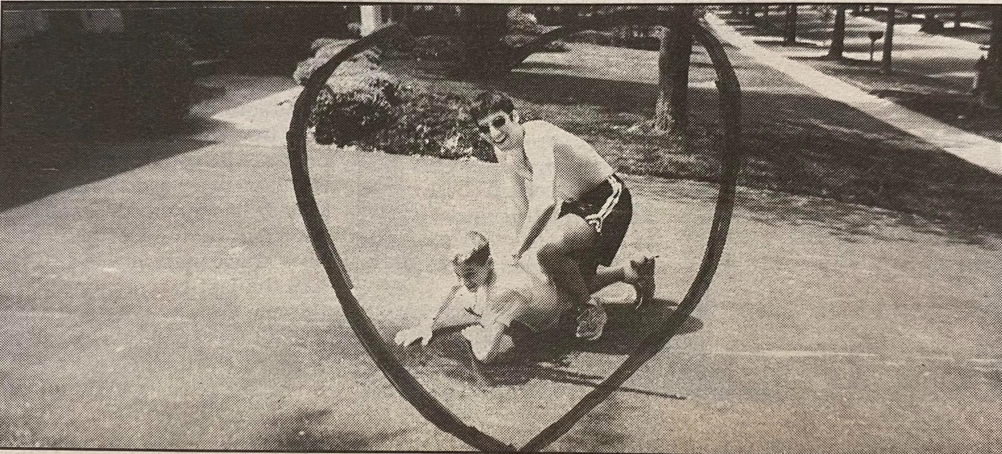 A WJ senior holds a Tilden Middle schooler on the ground on June 16, 1999. On that day, the senior class of 2000 raided the middle school at dismissal, pelting the younger students with water balloons and Supersoakers as they chased them to their buses. (Courtesy Pitch Archives)
