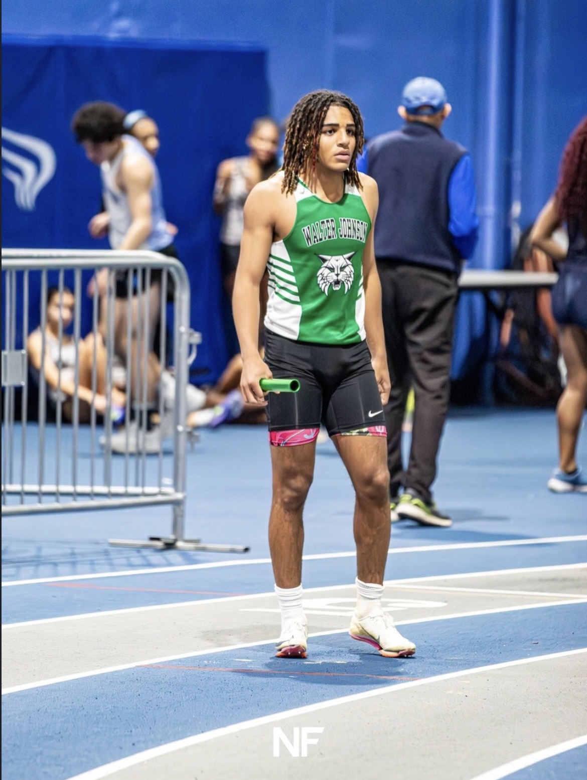 Senior Alessandro Marenco grasps the baton before leading off on the 4x200m relay at the MCPS #3 indoor meet. He went on to win this race alongside senior Ariel Stone, juniors Amadeo Apolinar and Jack Fiening, and will look to replicate similar success in his final outdoor season.