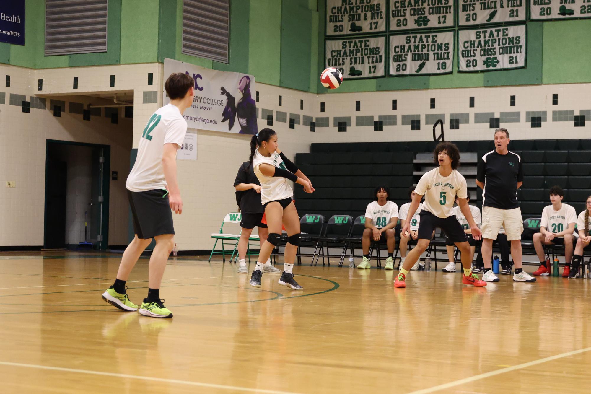 Junior Nicole Chang bumps the ball to a male teammate during a co-ed volleyball match last season. This spring, the Wildcats look to build their team chemistry.