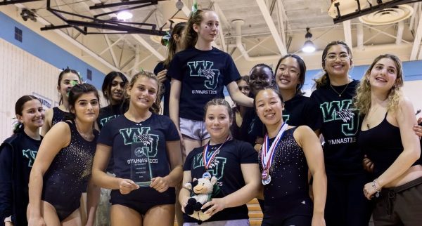 WJ Gymcats pose for victory after securing their hard-earned county champions title. This is the final year for MCPS gymnastics teams which made the title even more meaningful.