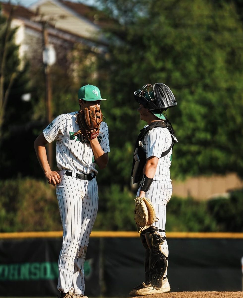 Sophomore pitcher Sam Grimley converses with catcher senior Sam Weston on the mound in their game against Wootton. The Cats went on to win 8-2. (courtesy Liam Snow)