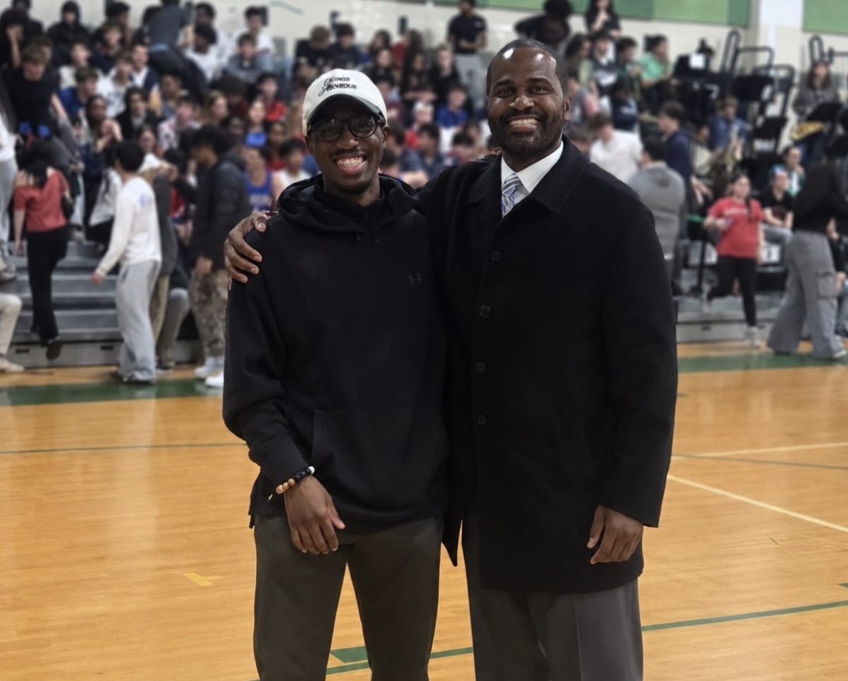 WJ introduces Samuel Sasu and Jaquis McCray at a basketball game against rival B-CC. This took place a month after they were announced to their respective positions. (Courtesy Larry Hurd)