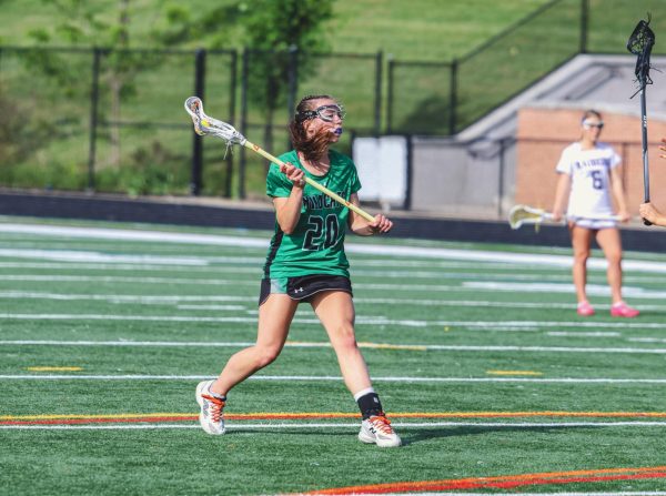 Sophomore captain Alina MacDermott charges toward the 12-meter fan against the Raider defense. Battling through injury, MacDermott scored two goals in the loss.